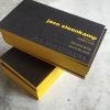 Stacked photo of the Luxury Edge Printed Debossed Business Cards in matt black with yellow