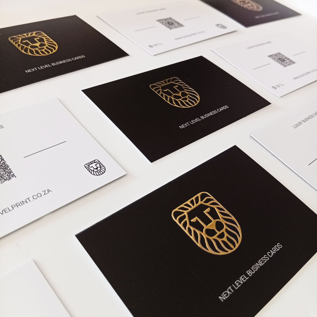 Close up of the Novel Print raised 3D Foiled Business Cards with gold logo and white wording: Next Level Business Cards
