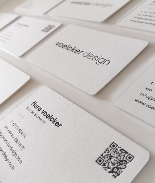 Grid of Minimalist black foiled business cards arranged portrait formation showcasing the black foil logo and contact details