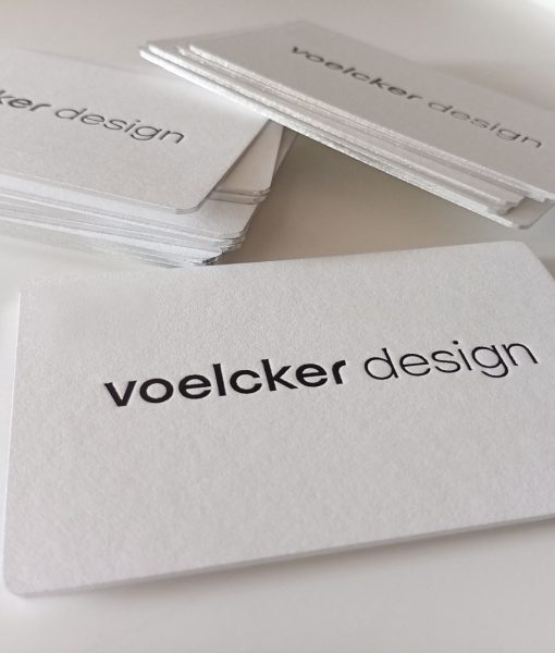 Close up of the metallic foil thick business card with black foil debossed logo