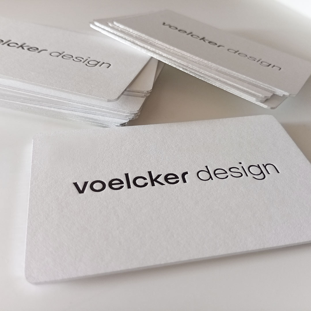Close up of the metallic foil thick business card with black foil debossed logo
