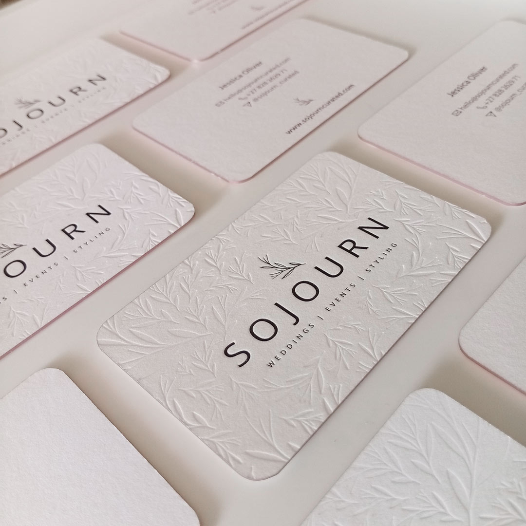 Letterpress logo and debossed pattern on these Elegant pink foil business cards