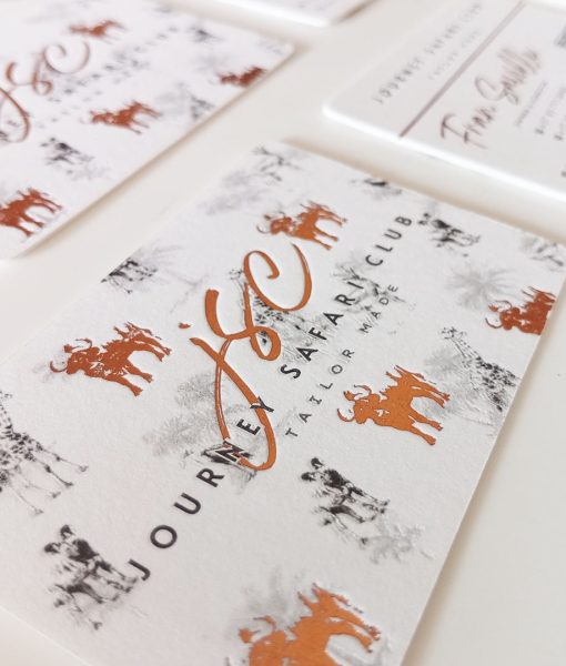 Detail of the copper or bronze foiled logo and printed illustration pattern in the background