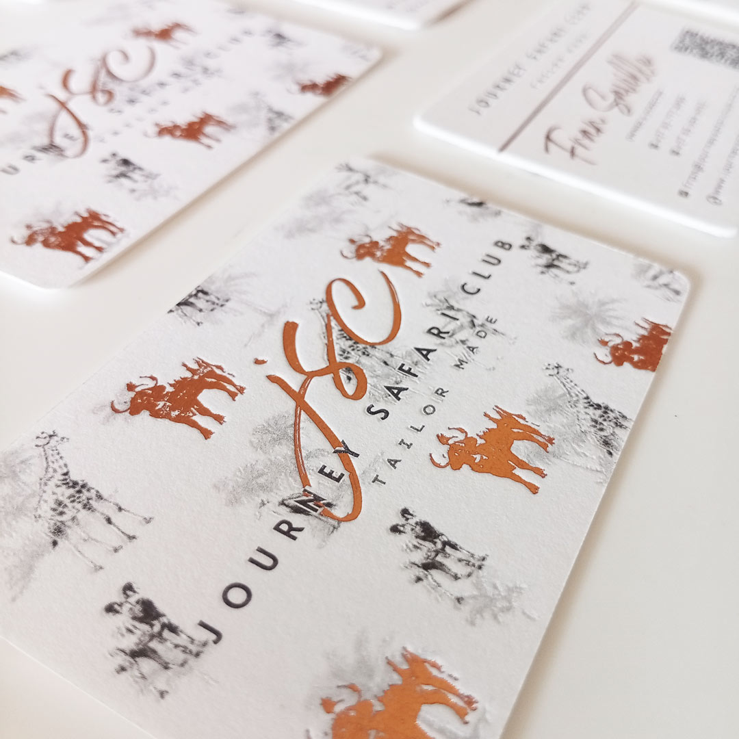 Detail of the copper or bronze foiled logo and printed illustration pattern in the background
