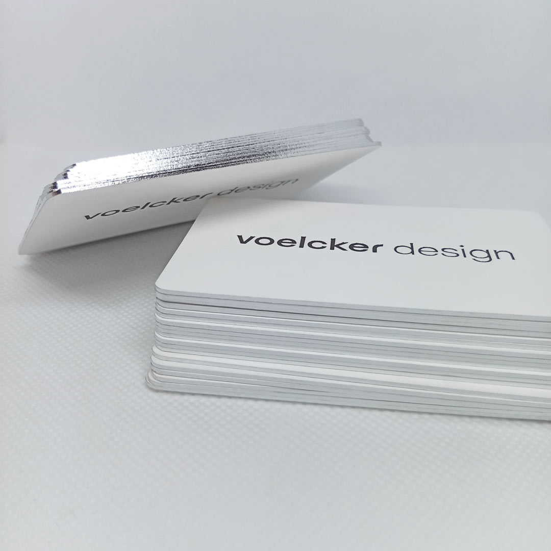 Side profile of a stack of Luxury Business Cards with shiny silver edge printed business cards