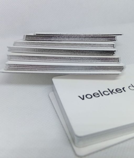 Loosely stacked side view of the silver edge foiled business cards with subtle shine