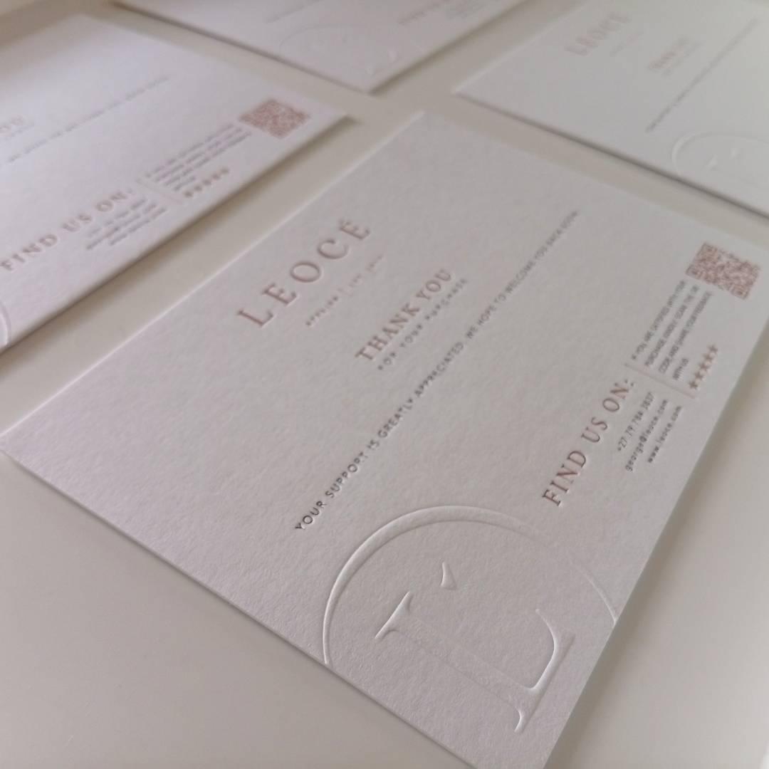 Perspective shot of a grid of 4 Debossed Letterpress Thank you Cards