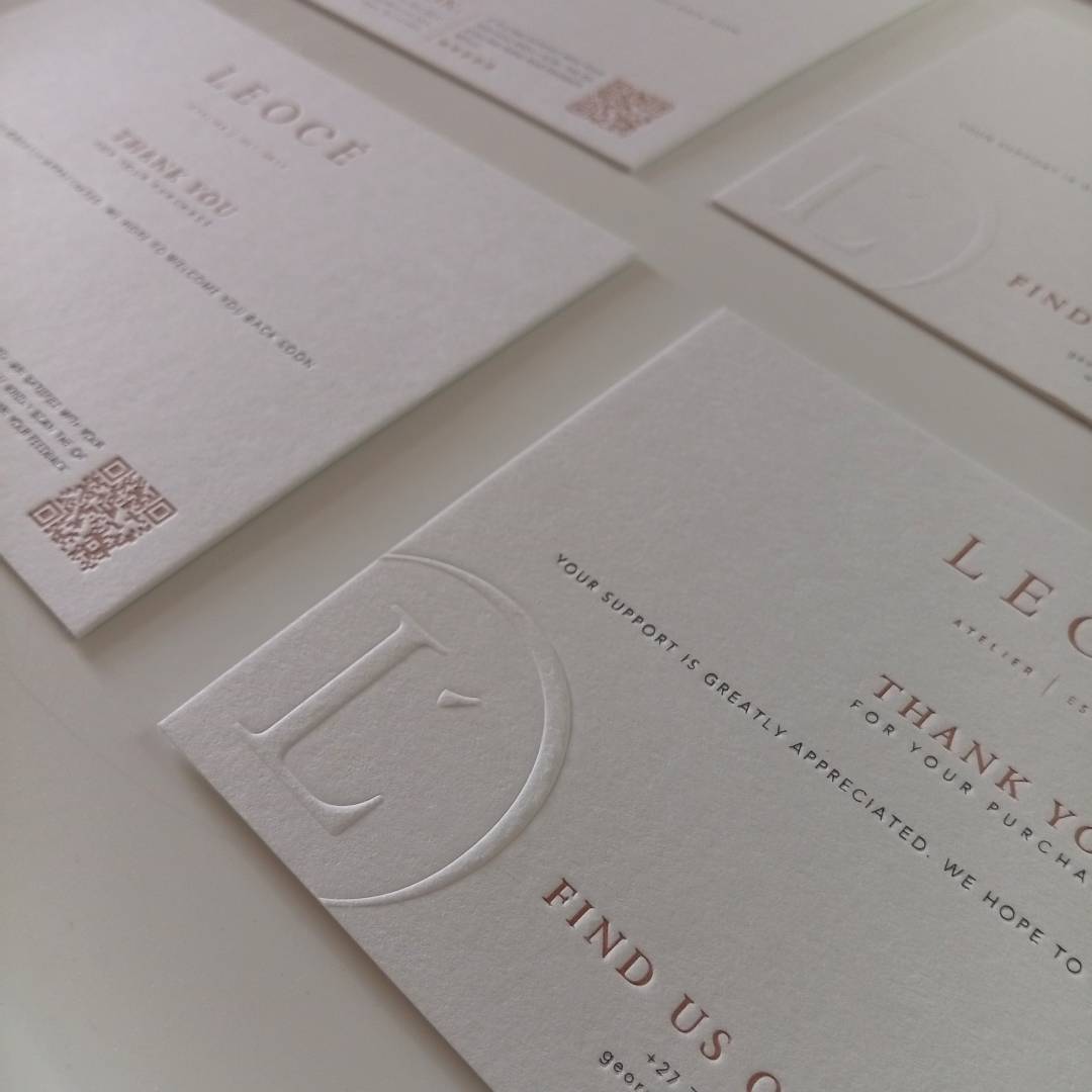 Angled perspective shot of 4 of the Letterpress Debossed Monogram invitation size Thank You Cards