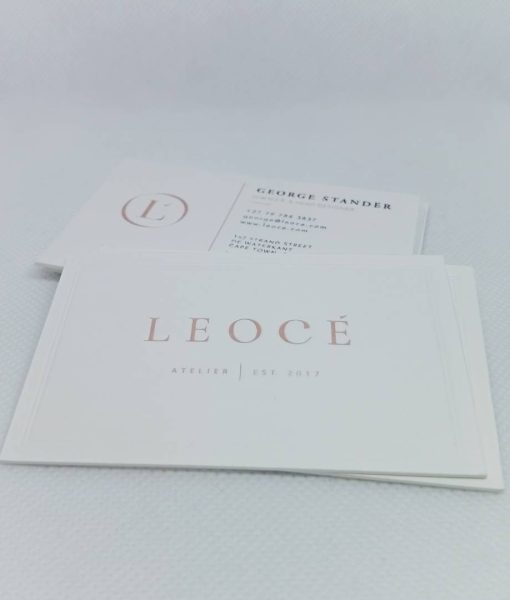 Front and back photos of pile of luxury and bespoke business cards for Leocé Couture